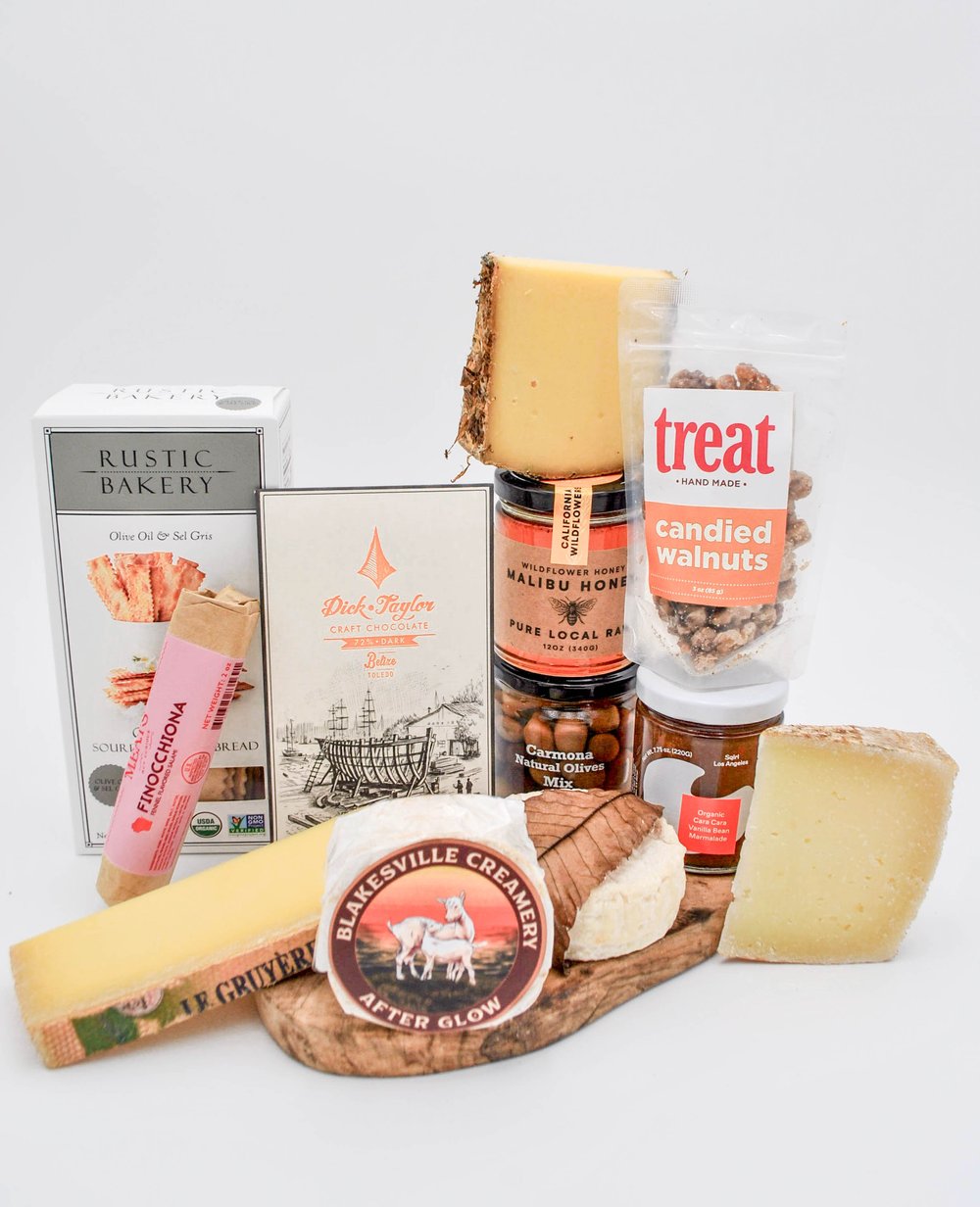 The San Vicente gift basket with artisanal cheese, preserves, chocolate, nuts, crackers, salami, olives, and gourmet goods.